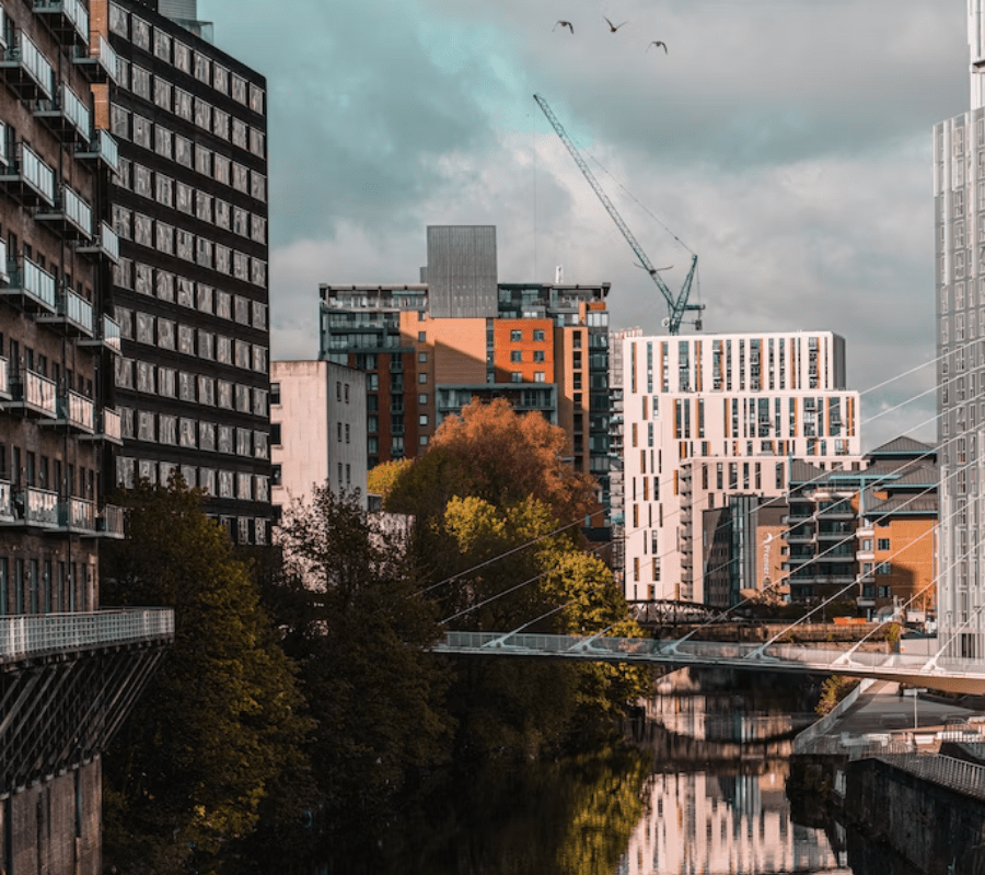 A backdrop of manchester showing construction cranes towering above the buildings.