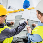 Two construction professionals are engaged in project planning exemplifying the strategic collaboration facilitated by construction recruitment agencies.